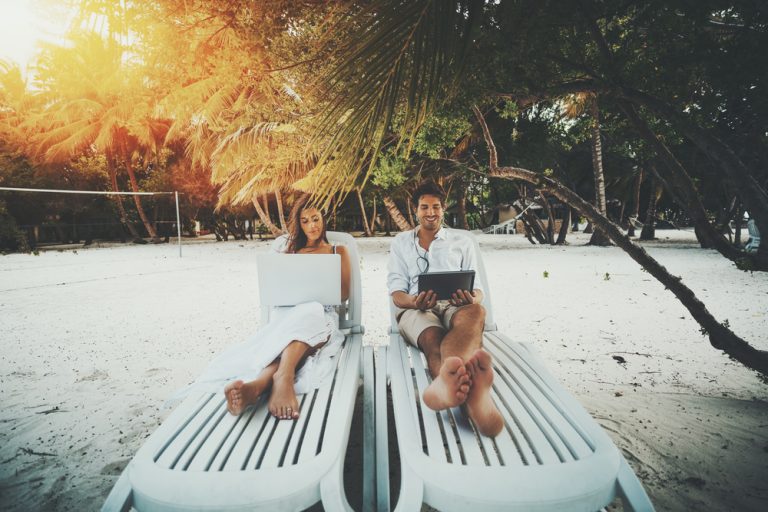 Work Life Balance - couple working on the beach